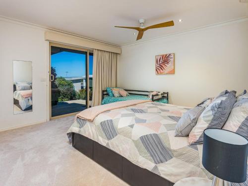 a bedroom with a large bed and a balcony at Ocean View in San Remo