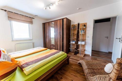 a bedroom with a bed and a chair in it at Schalkhaus Regensburg in Regensburg