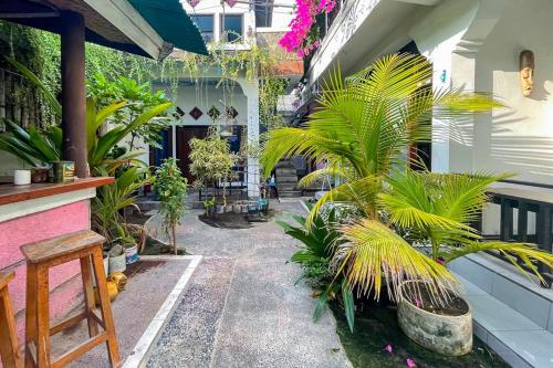 a courtyard of a house with palm trees and plants at 711 Gili Trawangan in Gili Meno