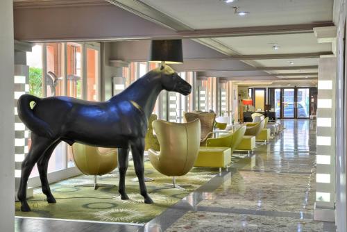 a statue of a horse in the lobby of a hotel at Plaza Hotel Capitole Toulouse - Anciennement-formerly CROWNE PLAZA in Toulouse