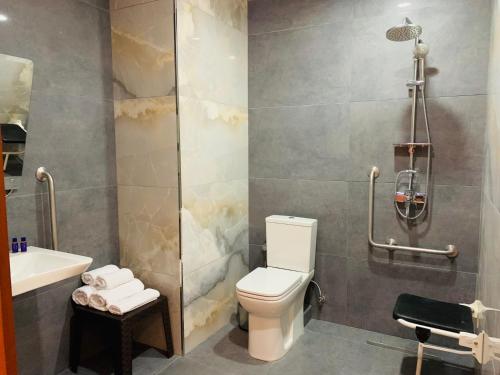a bathroom with a toilet and a sink at Neptun Palace Kvariati in Kvariati