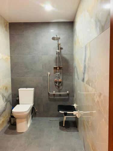 a bathroom with a toilet and a shower at Neptun Palace Kvariati in Kvariati