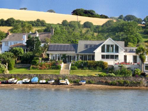 a large house on the shore of a body of water at Seaflowers in Kingsbridge