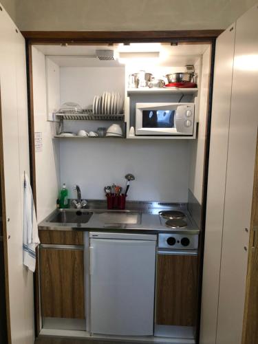 a small kitchen with a sink and a microwave at Residence Star in Turin