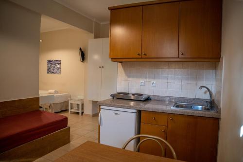 a kitchen with a sink and a counter top at Blue Sky Apartments in Malia