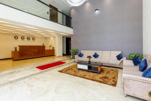 a living room with a couch and a table at Royal Ace Boutique Hotel in Bengaluru
