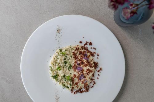 a white plate with some food on it at Blu Suite Resort in Bellaria-Igea Marina