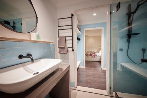a bathroom with a sink and a mirror and a shower at Gumtree Glen in Kangaroo Valley