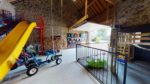 a play room with a slide and a playground at Ferienhof A&B Wellness Villa 12 personen in Bullange