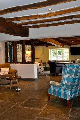 a living room with a couch and chairs and a table at The Hollybush Inn and B&B in Priors Marston