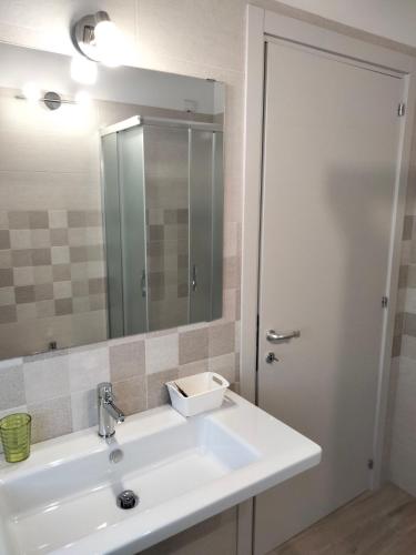 a bathroom with a white sink and a mirror at B&B La Casa di Giuliana in Cermignano