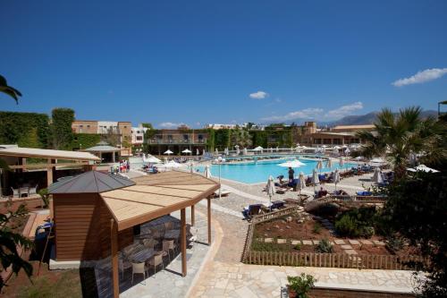 a large swimming pool with people in a resort at Bella Beach Hotel in Hersonissos