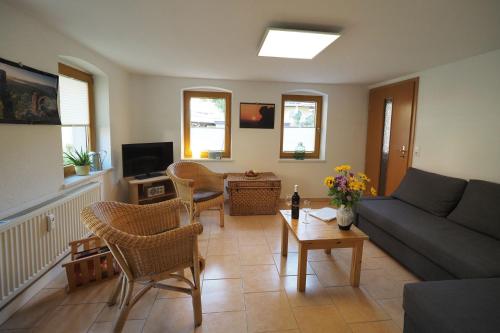 a living room with a couch and chairs at Haus Felsental in Rathen