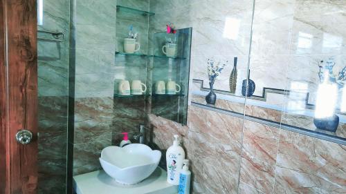 a bathroom with a shower with a sink at Sena home 4th-Rooftop Overlooking Danang Dragon bridge in Da Nang