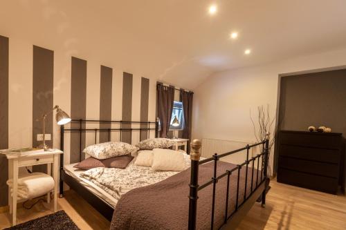 a bedroom with a bed with a striped wall at Apartment Klin in Bled