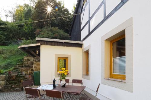 a patio of a house with a table and chairs at Haus Felsental in Rathen