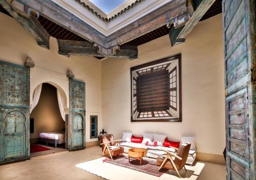 
a living room filled with furniture and a fire place at Hotel & Spa Dar Bensouda in Fez

