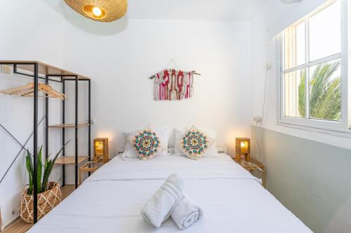 a bedroom with a white bed with two pillows at The White Hill Guesthouse in Yeroẖam