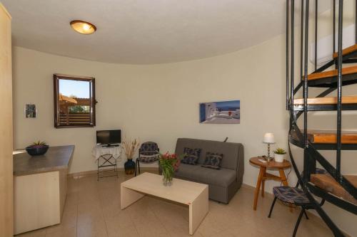 a living room with a couch and a bunk bed at Armonia Seaside Villas in Vasilikos