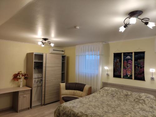 a bedroom with a bed and a desk and a chair at Oasis Apartments in Pärnu