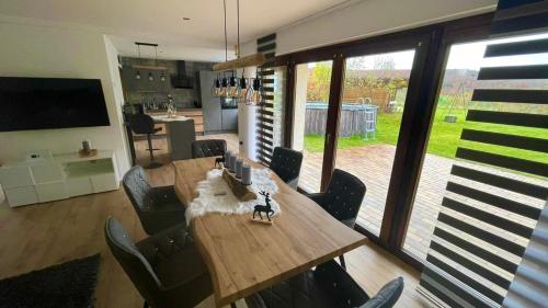 a dining room with a wooden table and chairs at Villa Vorkastell in Börfink