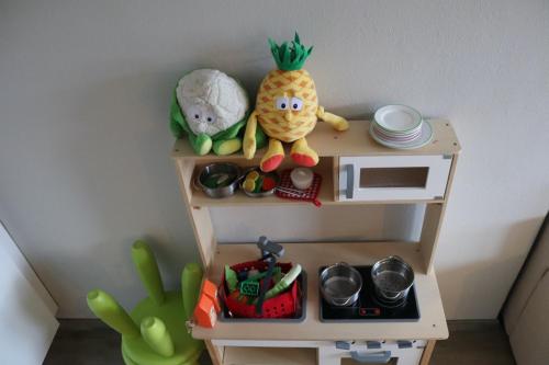 a toy shelf with some toys on top of it at Apartmenthaus Hinterer in Bad Goisern