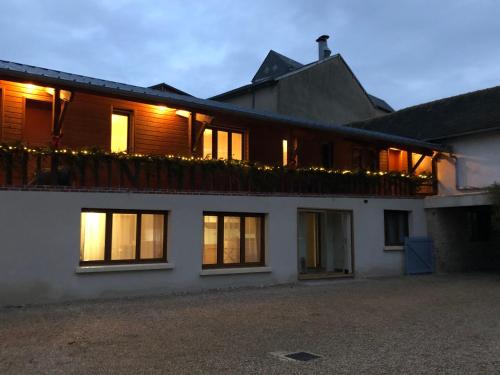 a house with a balcony with lights on it at Le Clos de la Tannerie in Saint-Aquilin-de-Pacy