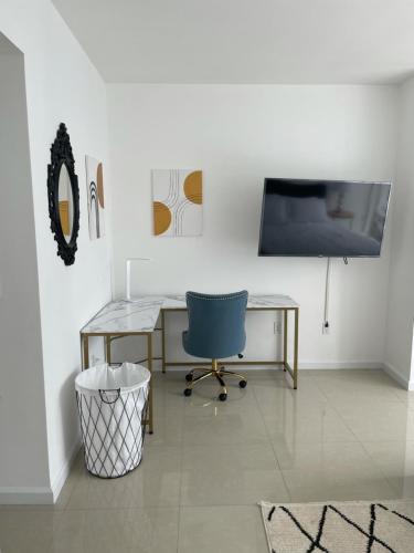 a room with a desk and a tv and a chair at IconBrickell Tower 3 W Residences in Miami