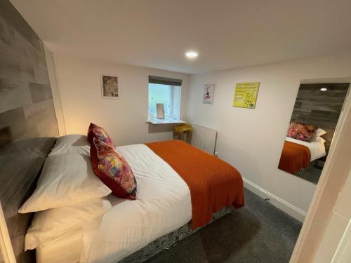 a bedroom with a bed and a mirror at Beautiful Georgian Duplex in Gloucester