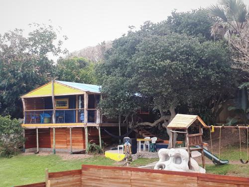 a house with a playground in front of it at Blue Space Beach Shack in Hibberdene