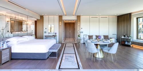 a bedroom with a bed and a table and chairs at The One Acropolis in Athens