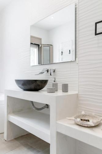a bathroom with a sink and a mirror at EtherealVilla-Family villa with pool in Lourdata