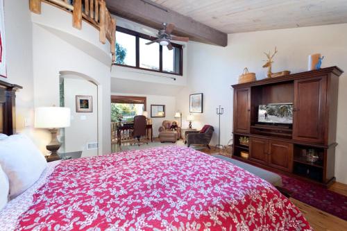 a bedroom with a large bed with a red blanket at Tamarron PineCone 854 in Durango