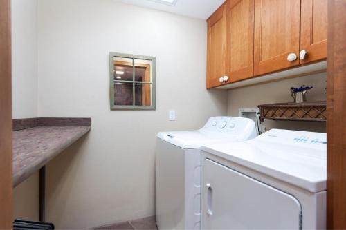 a small kitchen with a white washer and dryer at Tamarron PineCone 854 in Durango