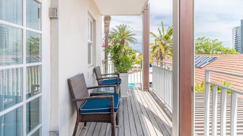 a balcony with chairs and a view of the ocean at The Glen Boutique Hotel & Spa in Cape Town