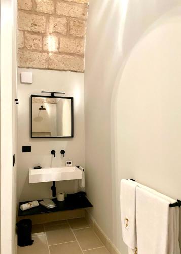 a bathroom with a sink and a mirror at Villa Di Noi in Arnesano