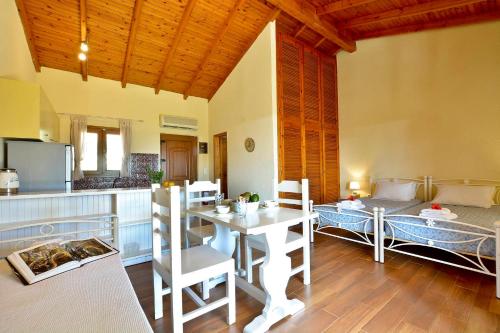 a kitchen and a dining room with a table and a counter at Renata Rooms & Studios in Barbati