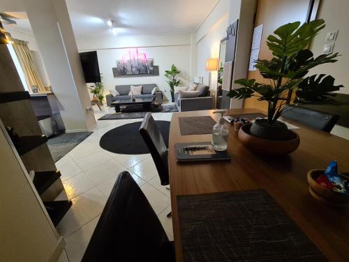 a living room with a table with a potted plant at Luxury Home in Spáta