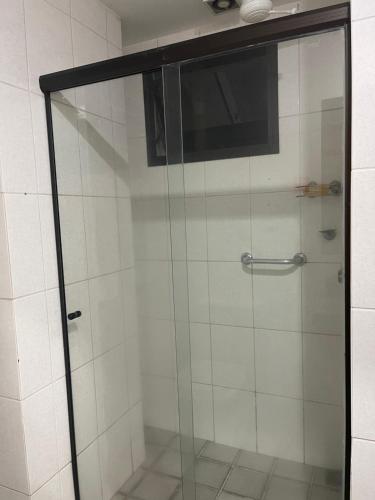 a shower with a glass door in a bathroom at Flat Pasárgada Encantador 616 in Vila Velha