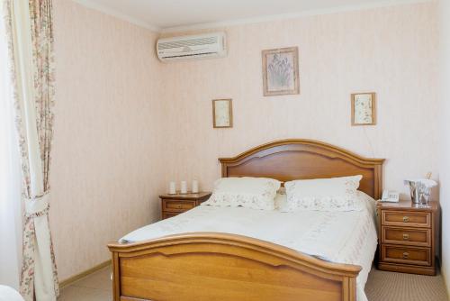 a bedroom with a wooden bed and a wooden dresser at Zolota Gora Hotel-Rancho in Uzhhorod