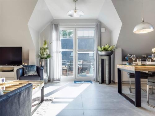 a living room with a couch and a table at Haus MEERLE in Zingst