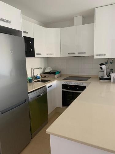 a kitchen with white appliances and white cabinets at Naranjo 7 - N565 - 2 bathrooms Apartment in Alhama de Murcia Golf Resort in Alhama de Murcia