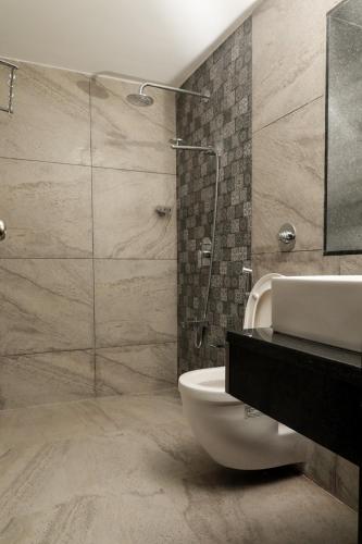 a bathroom with a sink and a toilet and a shower at Sao Domingos in Cavelossim