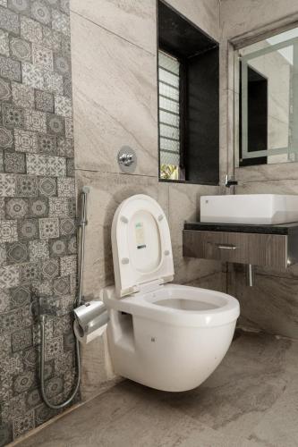 a bathroom with a white toilet and a sink at Sao Domingos in Cavelossim