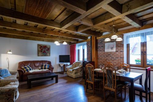 a living room with a couch and a table at Wellness Chata Chmaroška - Telgárt Resort in Telgárt