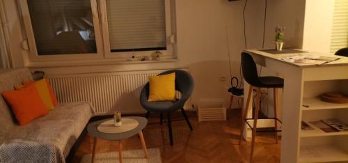 a living room with two chairs and a couch at Studio apartman Tonka in Vinkovci