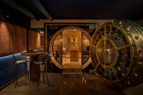 a room with a large wooden barrel and a bar at voco The Hague by IHG in The Hague