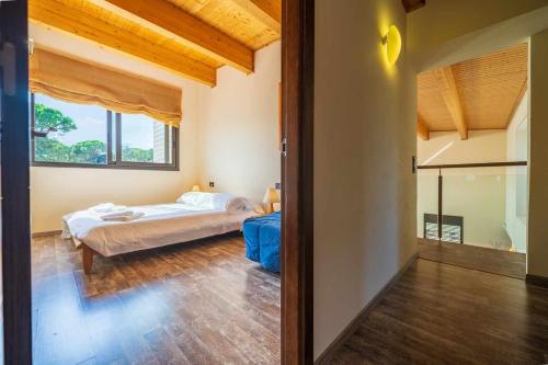 a bedroom with a bed and a large window at Villa Mestres Playa de Aro in Platja  d'Aro