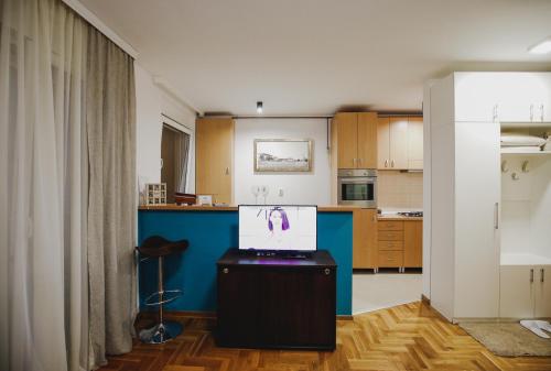 a kitchen with a tv on top of a table at Prestige apartment in Gornji Milanovac