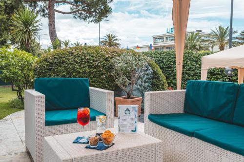 a patio with two chairs and a table with a drink at Hotel Santa Maria in Chiavari